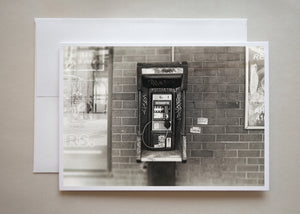 This is a gritting black and white photograph of a Toronto pay phone with graffiti tags all over by photographer Caley Taylor.