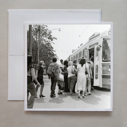 In 2010, Caley photographed a series of black and white, 6x6 film photographs showing downtown Toronto scenes.  This photograph shows a line up of TTC customers entering a TTC streetcar by photographer Caley Taylor.